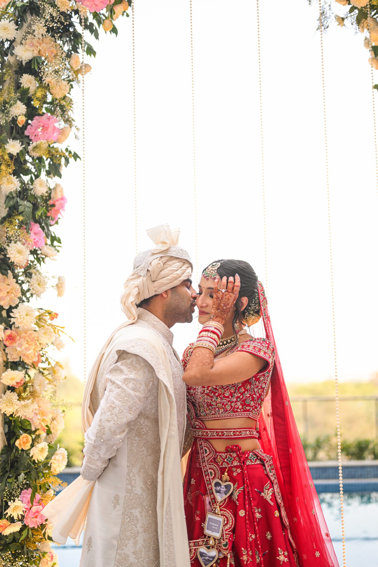 a bride and groom at the mandap, foreheads close